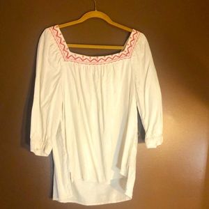 white shirt with embroidered red design